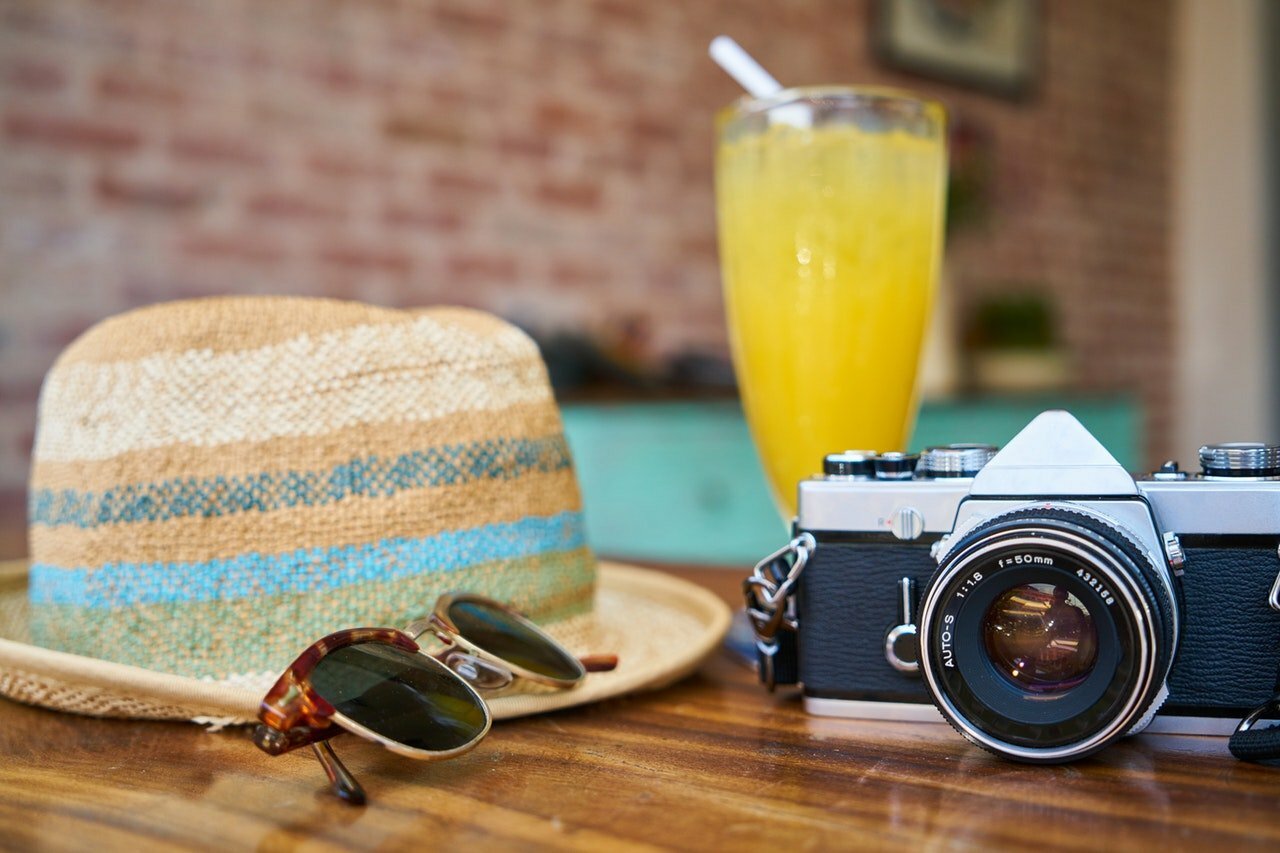 a camera and a hat on a table