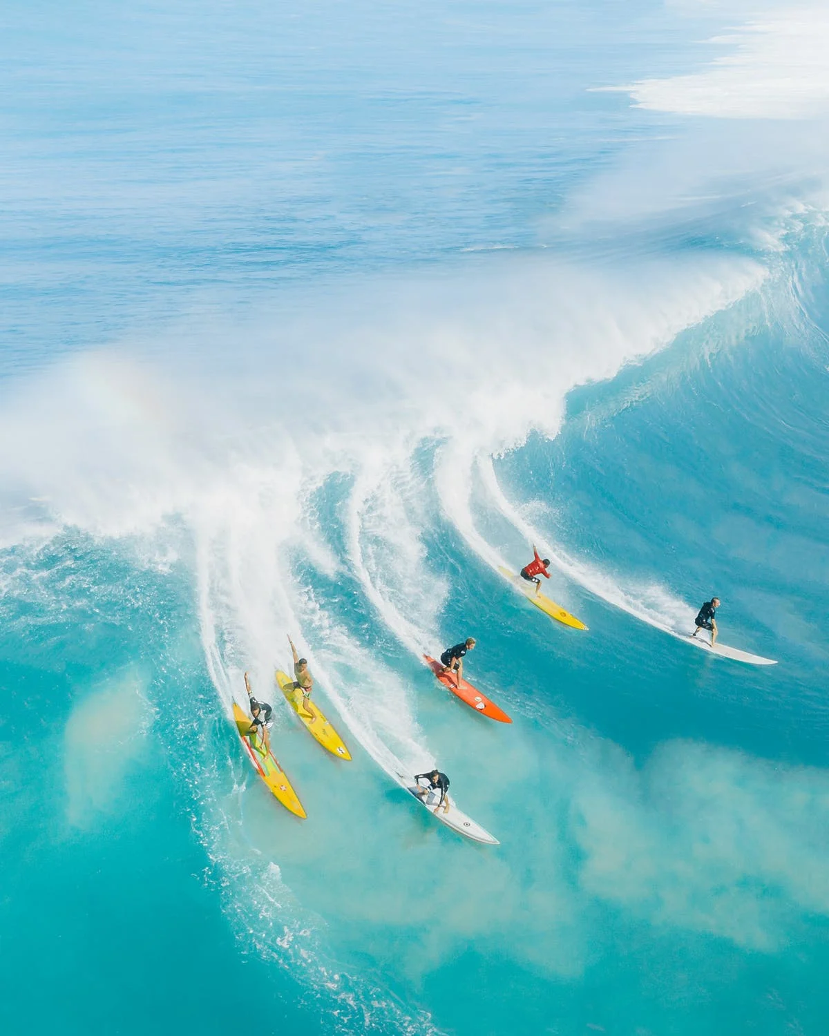 Aerial view of surfers riding large waves, Alabama state parks and outdoor activities.